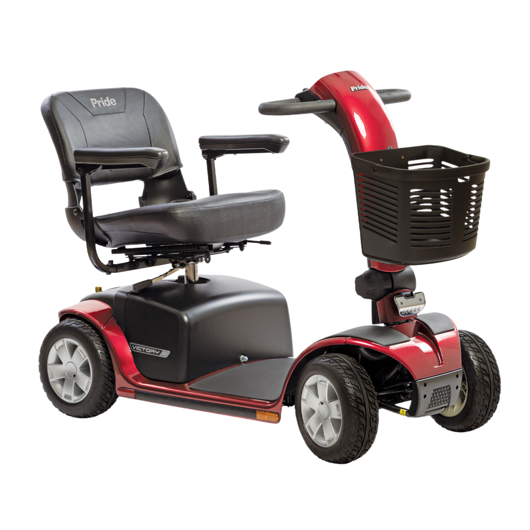 A red and black Pride Mobility Victory® 10 4-Wheel Scooter with EZ Turn features a padded seat, armrests, four wheels, a front basket, and visible Pride branding on the seat and control panel.